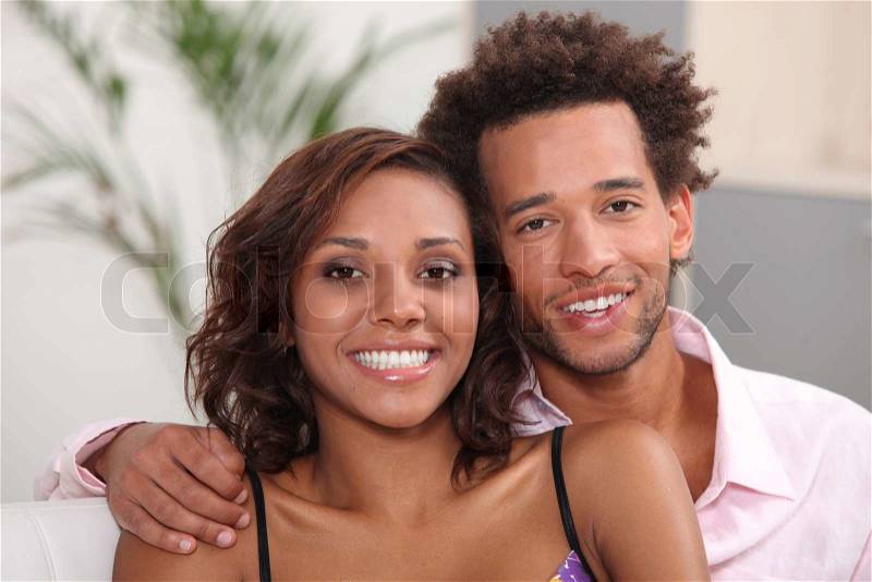 Young couple relaxing at home, stock photo