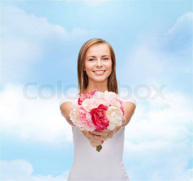 Holidays, love and flowers concept - young woman with bouquet of flowers, stock photo