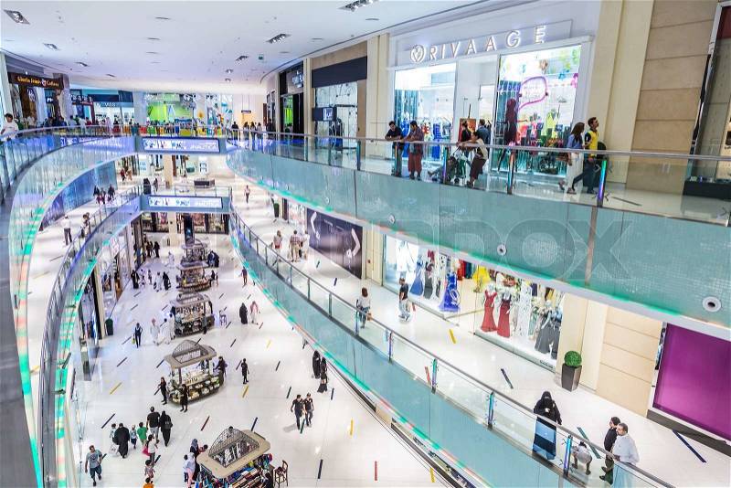 DUBAI, UAE - NOVEMBER 14: Shoppers at Dubai Mall on November 14, 2012 in Dubai. At over 12 million sq ft, it is the world\'s largest shopping mall based on total area and 6th largest by gross leasable area, stock photo