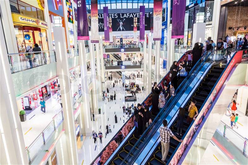 DUBAI, UAE - NOVEMBER 14: Shoppers at Dubai Mall on November 14, 2012 in Dubai. At over 12 million sq ft, it is the world\'s largest shopping mall based on total area and 6th largest by gross leasable area, stock photo
