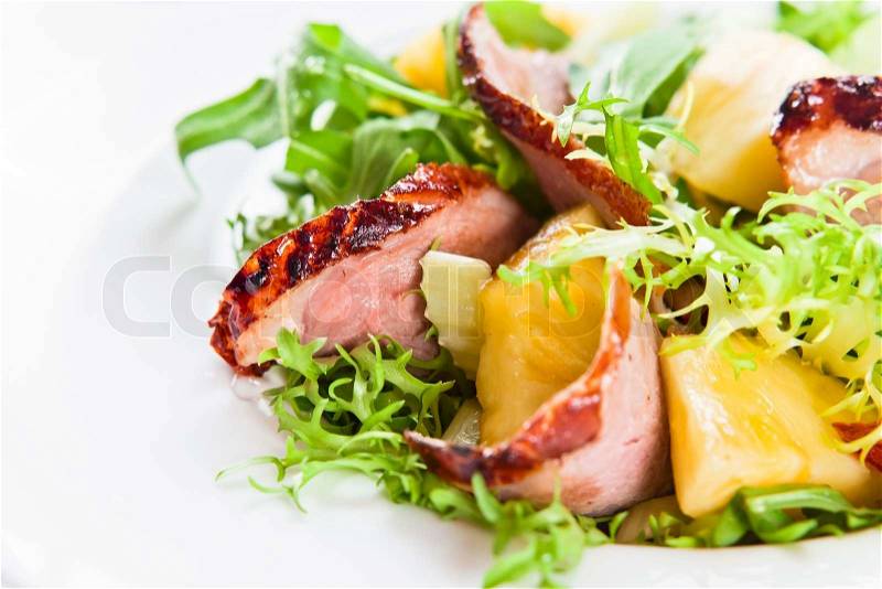 Salad with greens, pineapple and smoked meat, stock photo