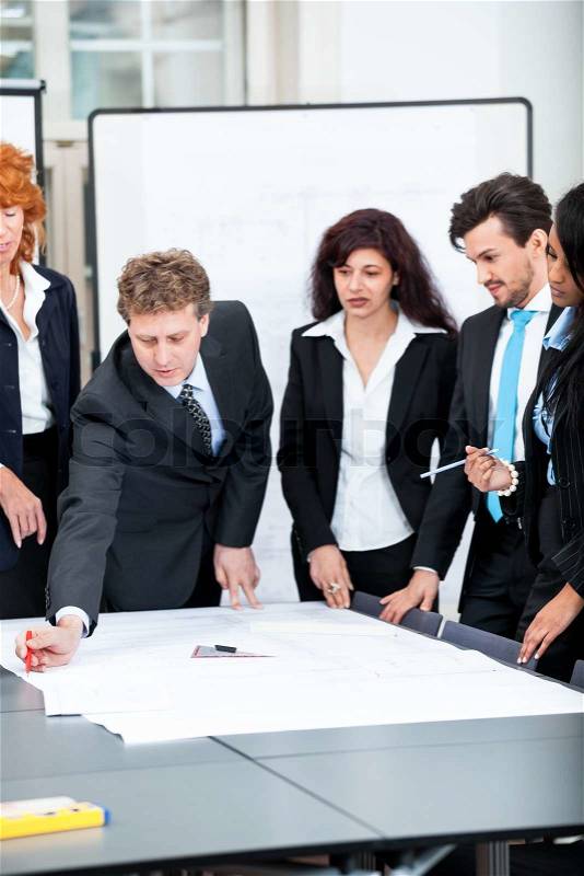 Business people discussing architecture plan sketch in office, stock photo