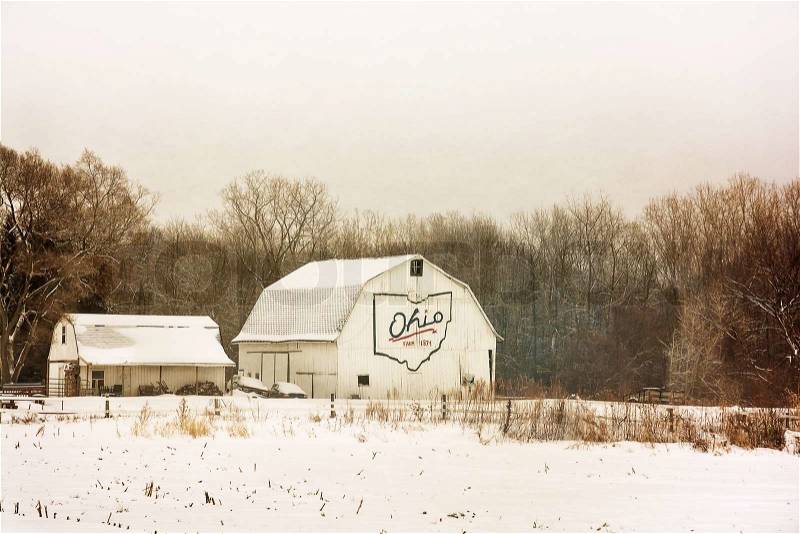 Winter snow scene with an old historic Ohio barn covered with snow. , stock photo