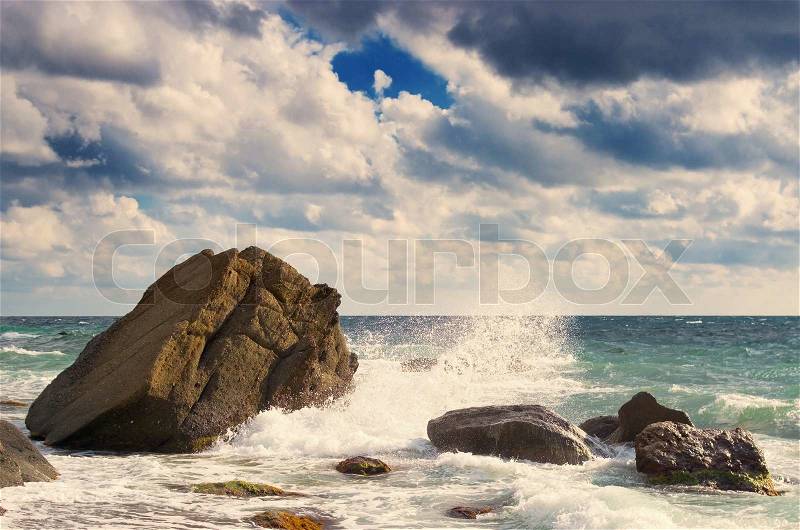 sea waves rolling on stones, stock photo