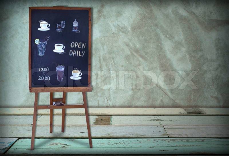 Open daily coffee shop blackboard in green coffee room, stock photo