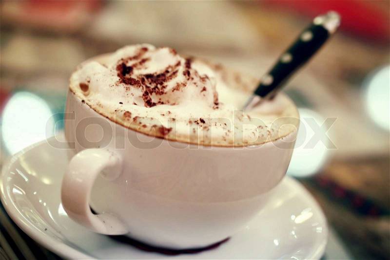 White cup of cappuccino coffee. Vintage toned photo, stock photo