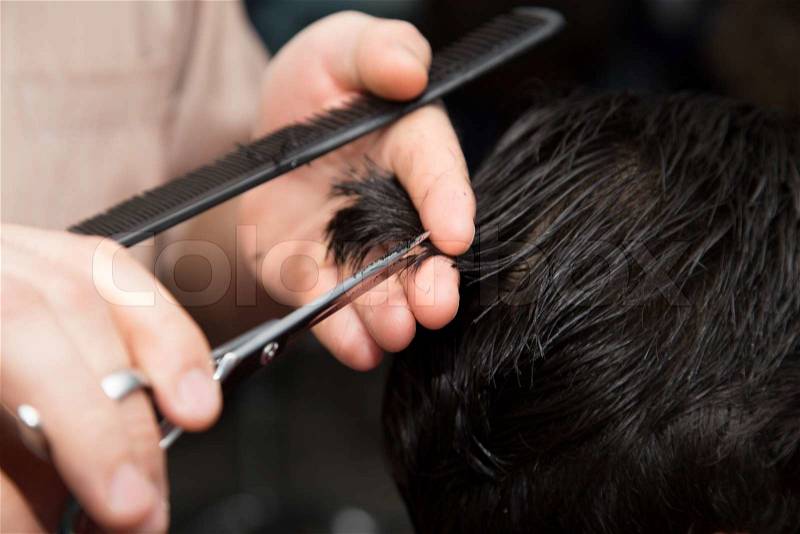 Men's haircut scissors at salon, stock photo