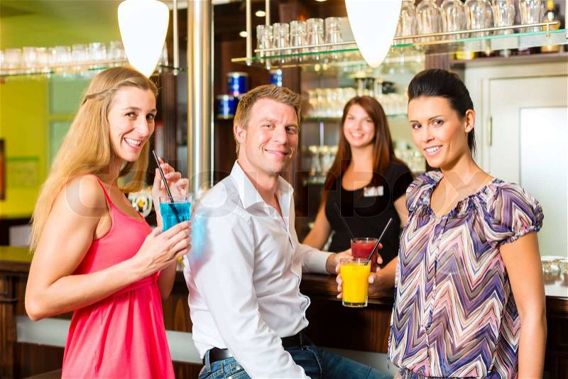 Young people drinking cocktails in bar having fun, stock photo