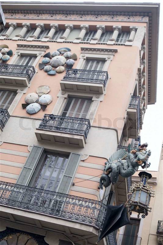 Details of an Asian design on a building in Barcelona featuring umbrellas, fans and a dragon, stock photo