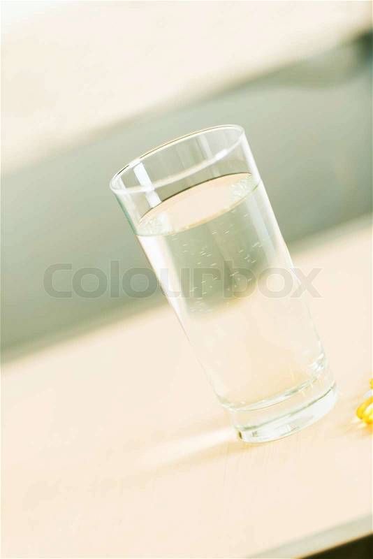 Glass of water and pills with copy space, stock photo