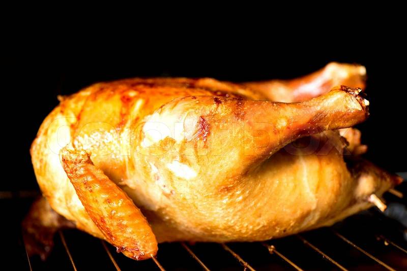 Roasted chicken in oven closeup horizontal, stock photo