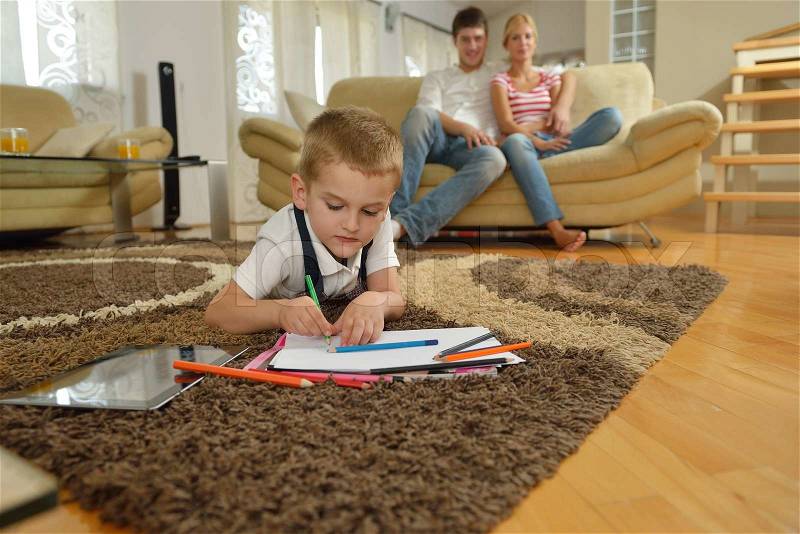 Happy young family with kids in bright modern living room have fun and looking big flat lcd tv, stock photo