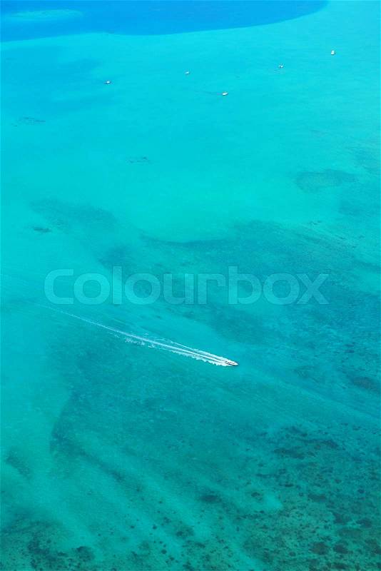 Fast motor speed boat travel with splash and wake on blue tropical sea backround, stock photo