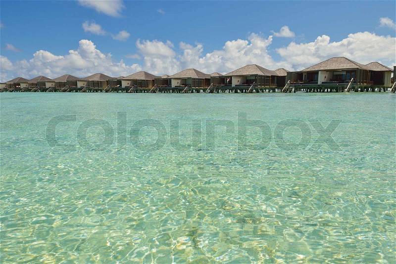Tropical water home villas resort on Maldives island at summer vacation, stock photo