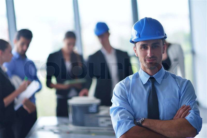 Business people group on meeting and presentation in bright modern office with construction engineer architect and worker looking building model and blueprint planbleprint plans, stock photo