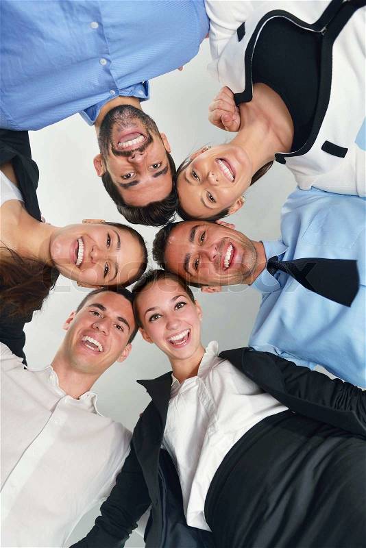 Business people group joining hands and representing concept of friendship and teamwork, low angle view, stock photo