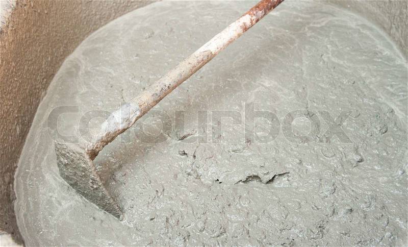 Spade and wet cement image for construction process, stock photo