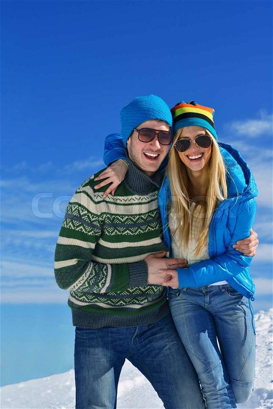 Young Couple In winter Snow Scene at beautiful sunny day, stock photo