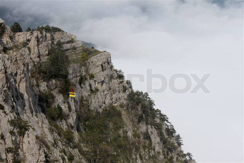 Aerial ropeway cabin going up to mountain, stock photo