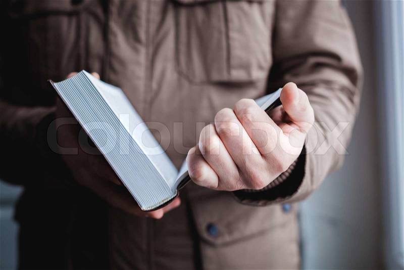 Man reading. Book in his hands, stock photo