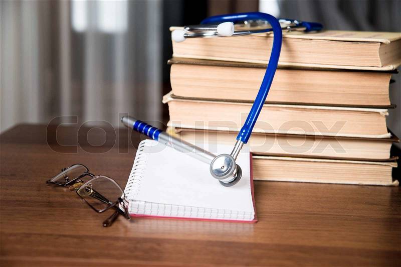 Stethoscope. medical records, and books, stock photo