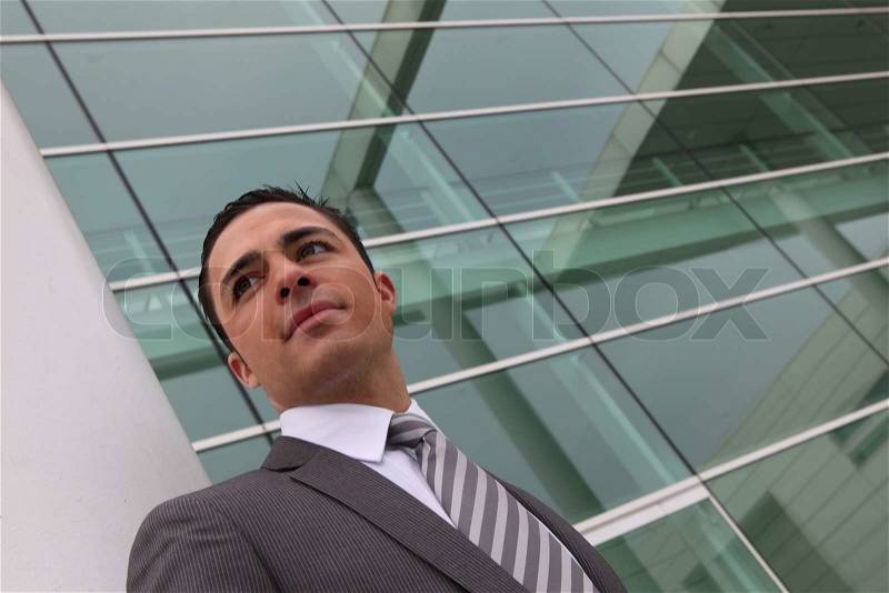 Businessman outside an office building, stock photo