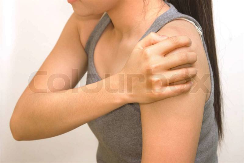 Woman holding her shoulder for the pain, stock photo