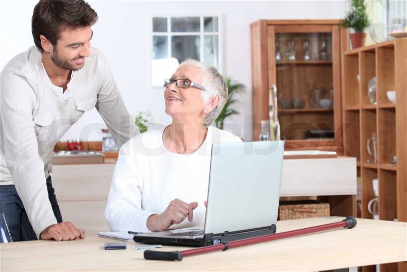 Elderly woman on laptop, stock photo