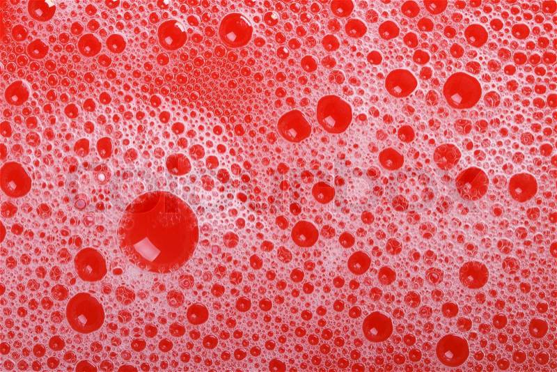 Foam and soap bubbles on red background close-up. macro texture , stock photo