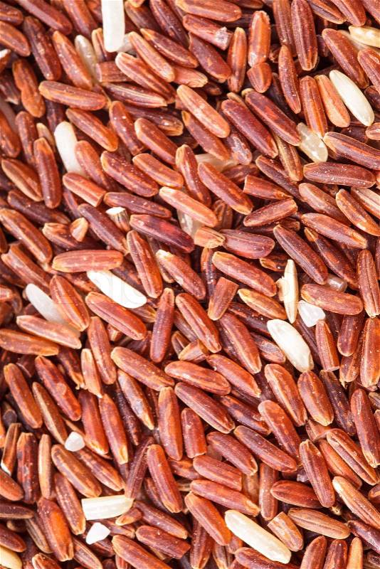 Red rice scattered as a background. Food design, stock photo