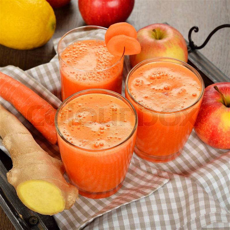 Fresh apple and carrot juice on brown background, stock photo