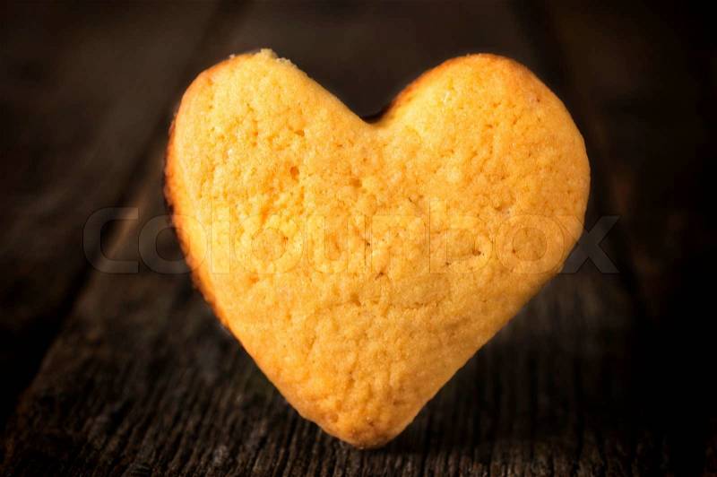 Selective focus on the heart shape cookies on the wooden background, stock photo