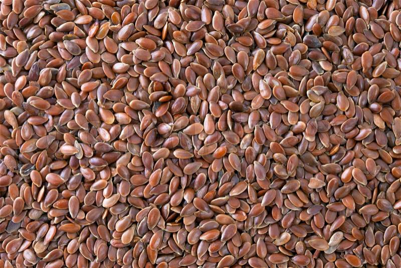 Flax seeds (Linum usitatissimum) texture background. Also called common flax or linseed. Used as an ingredient in paints, fiber and cattle feed, produce a vegetable oil. The plant is also used in medicine, stock photo
