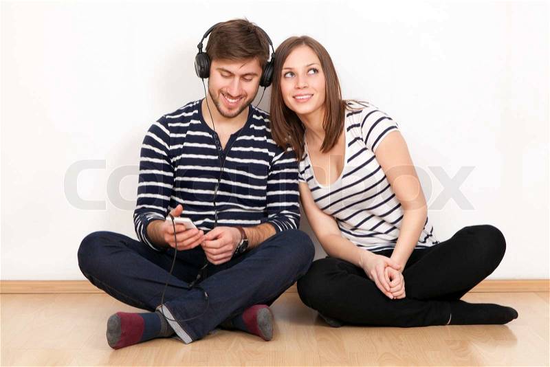 Two people listening to music together, stock photo