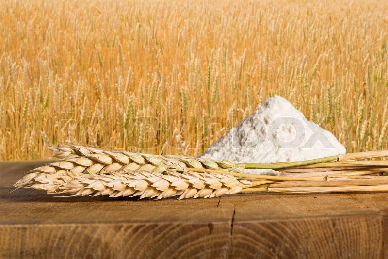 Bread, flour and wheat cereal crops. Cereal crops on the background, stock photo