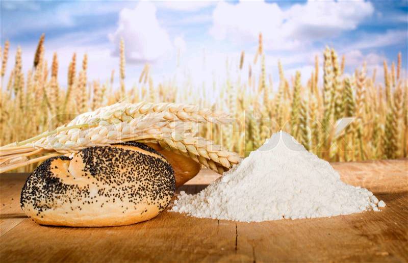 Bread, flour and wheat cereal crops. Cereal crops on the background, stock photo