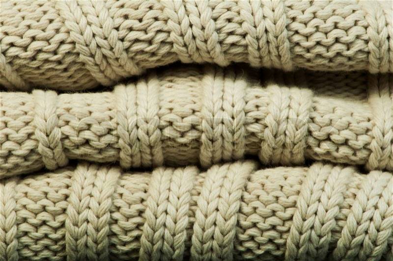 Old knit sweater background. Beige color. Studio shot, stock photo