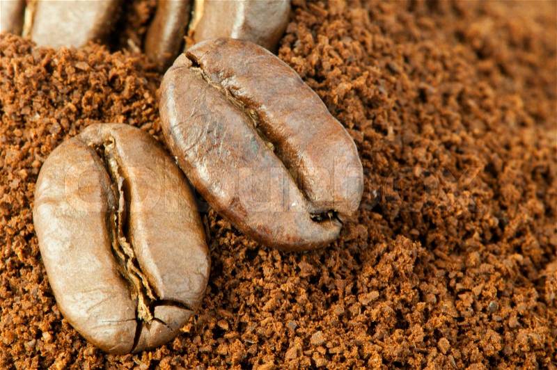 Coffee beans and ground coffee close up, stock photo