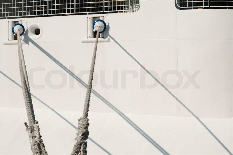 Ship ropes and moored ship close up, stock photo