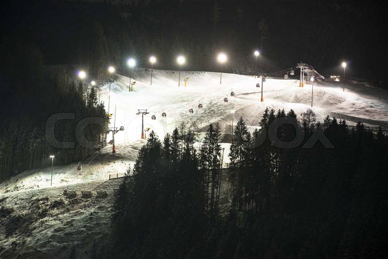 Night skiing on the piste of Saalbach-Hinterglemm in Austria, stock photo