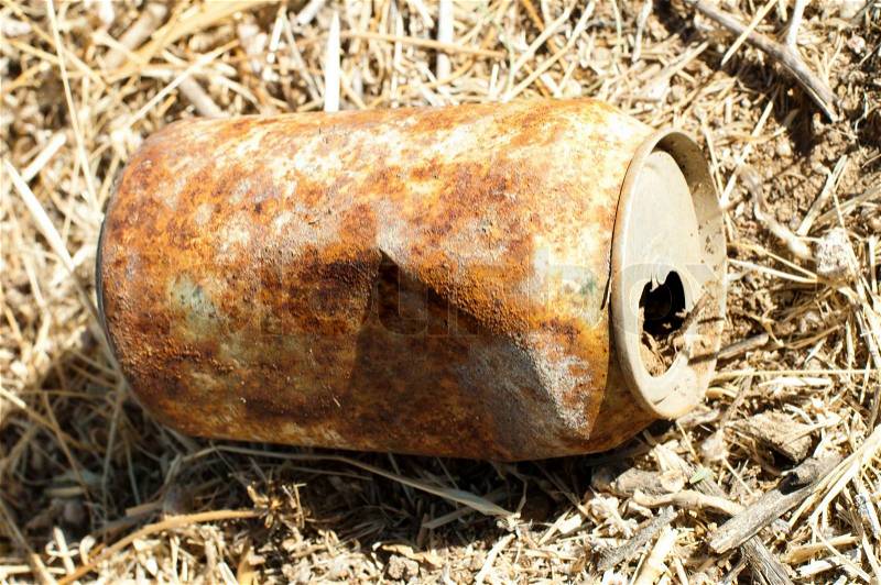 Old rusty can of soft drink on the land, stock photo