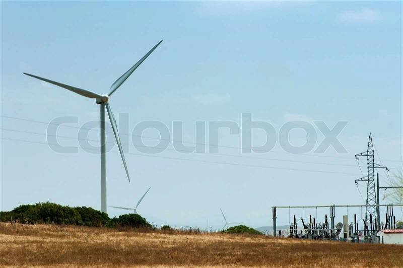 Wind generator and electrical substation. Blue sky, stock photo