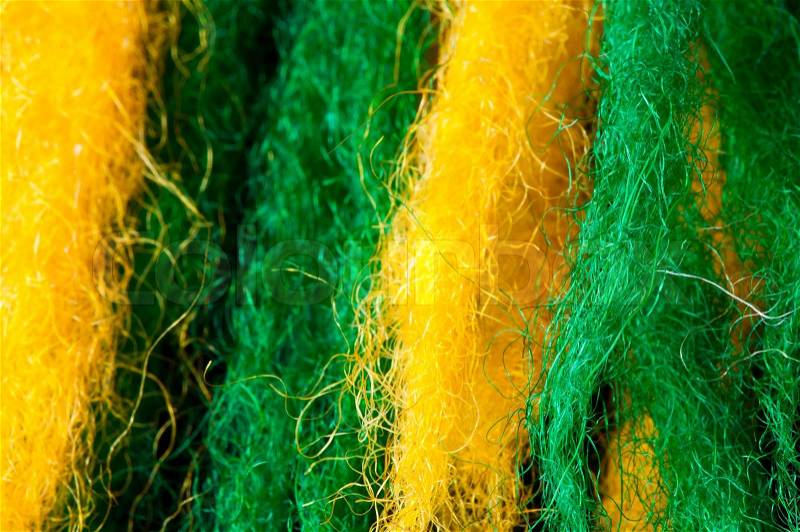 Green and yellow wool fibers closeup, stock photo