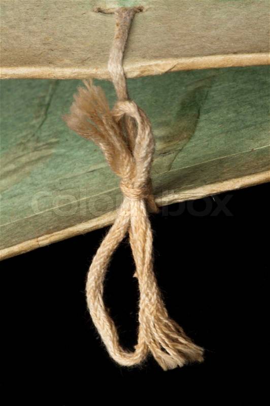Old tattered folder tied with rope, stock photo