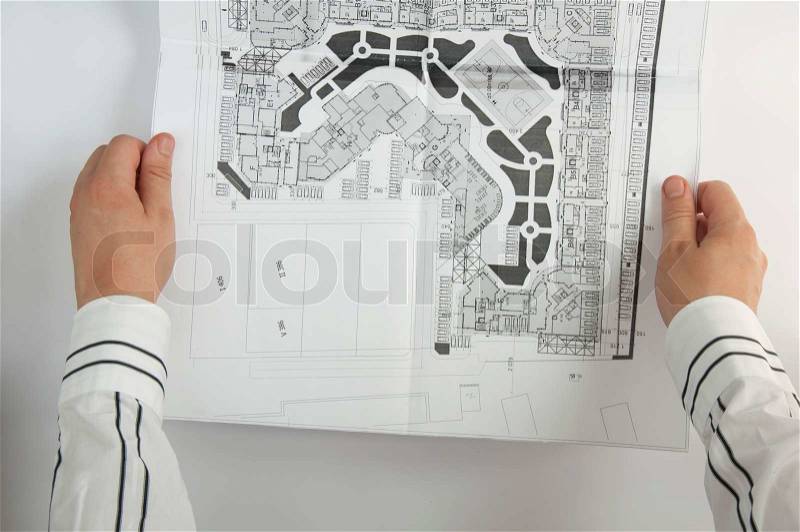 Sketch plan of building construction. Two hands of architect, stock photo