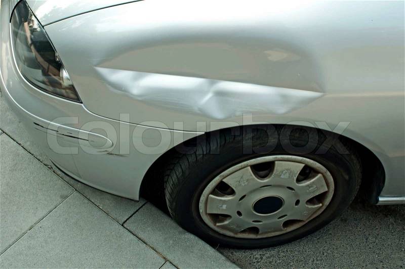 Scraped and crushed car fender, stock photo