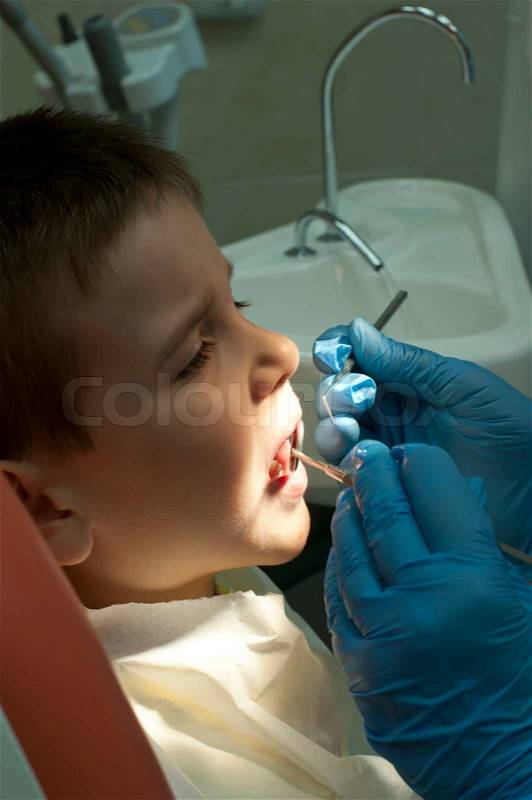 Child in a dentist\'s chair in cabinet, stock photo