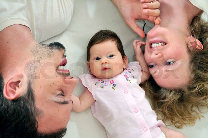 Indoor portrait with happy young family and cute little babby , stock photo