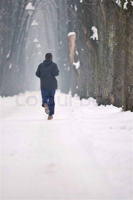 One older man running at alley on winter seasson at early morning, stock photo