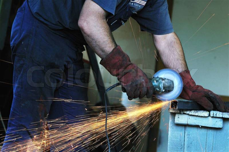 Industry worker cut steel with spinning machine and spark, stock photo